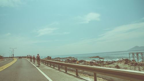 Empty road against cloudy sky