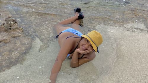 High angle view of woman lying on beach