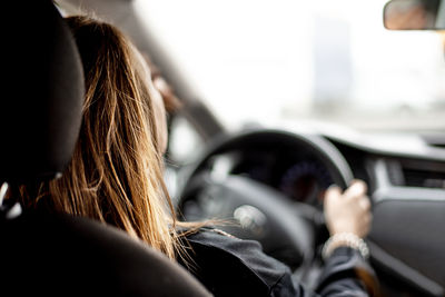 Rear view of woman in car