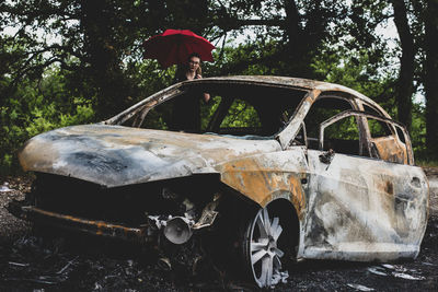 View of abandoned car on land