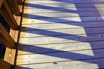 High angle view of shadow on wooden floor