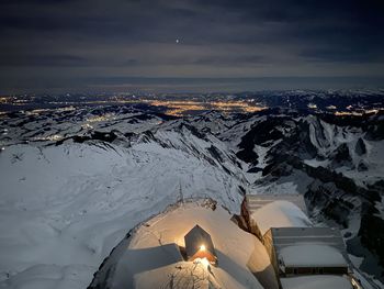 Aerial view of snowcapped mountain against sky during winter