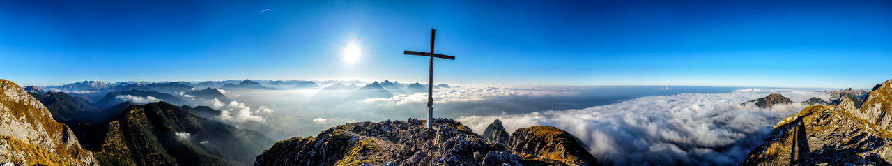 Panoramic view of snowcapped mountains against blue sky