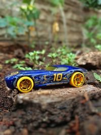 Close-up of yellow toy car on field