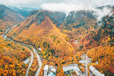 High angle view of trees by mountains during autumn