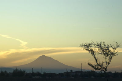 Scenic view of silhouette mountains against orange sky