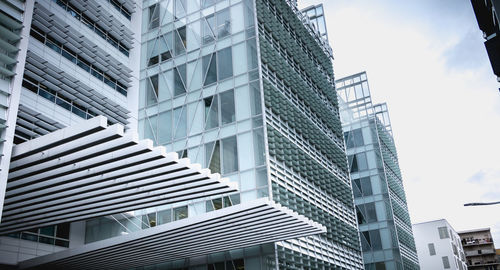 Low angle view of modern buildings in city against sky