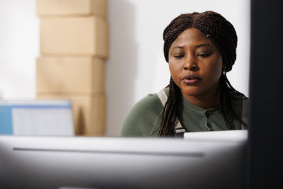 Portrait of young woman using laptop at table