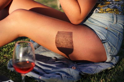 Shadow of wineglass on woman sitting outdoors