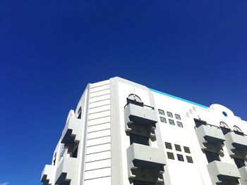 Low angle view of building against clear blue sky