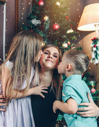 Mother and girl with christmas tree