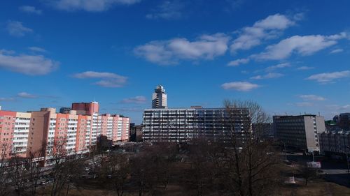 Buildings in city against blue sky