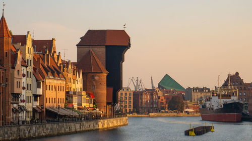 Buildings in city at sunset