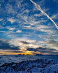 Scenic view of snowcapped mountains against sky during sunset