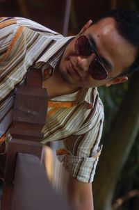 Portrait of young man wearing sunglasses standing outdoors