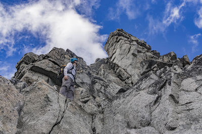 Low angle view of person against mountains against sky