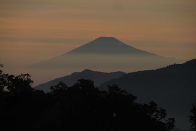 Scenic view of silhouette mountains against sky during sunset