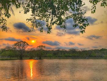 Scenic view of lake against orange sky