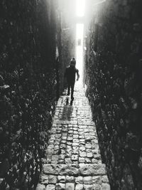 Man walking on footpath amidst trees