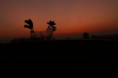 Silhouette of basket against sky during sunset