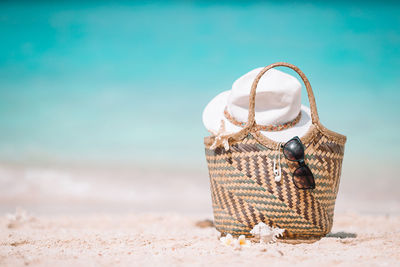 Close-up of gift on sand at beach