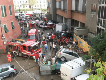 High angle view of vehicles on road along buildings