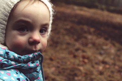 Close-up portrait of cute baby girl in warm clothing