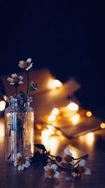 Close-up of illuminated lamp on table