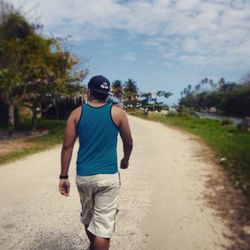 Rear view of woman walking on road