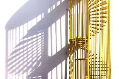 Yellow spiral staircase against wall