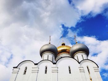 Low angle view of building against cloudy sky