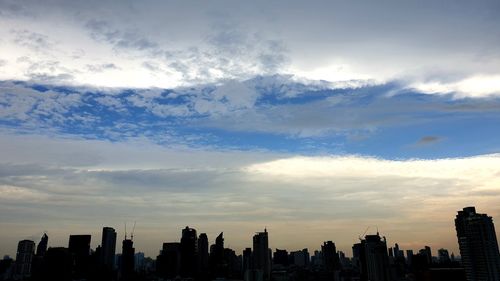 View of modern buildings against cloudy sky