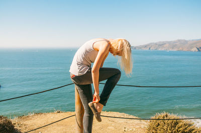 Rear view of woman standing on beach