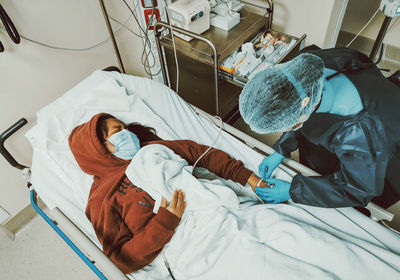 High angle view of woman lying on bed