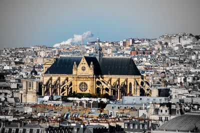 Saint-eustache church amidst townscape against sky