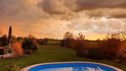 Scenic view of field against sky during sunset