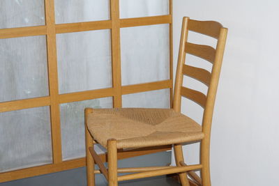 High angle view of empty chair on table at home
