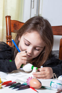 Portrait of girl holding ice cream on table