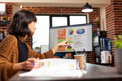 Businesswoman using laptop at table