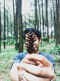 Portrait of person holding umbrella in forest