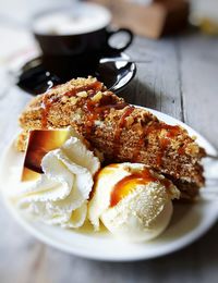 Close-up of cake with ice creams in plate on table