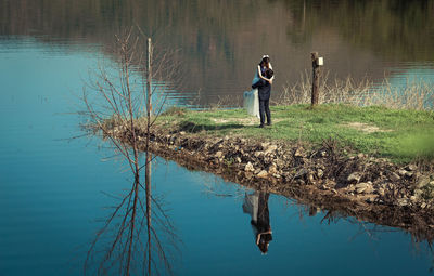 Full length of man standing on lake