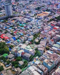 High angle view of tree and buildings in city