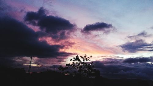 Low angle view of silhouette trees against sky