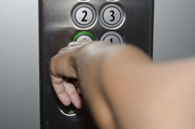 Cropped hand pressing elevator button