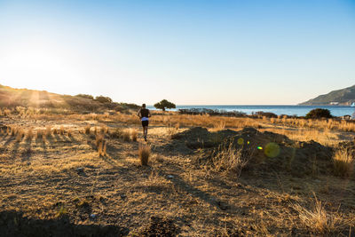 Man standing on land against sky