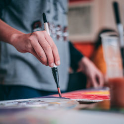 Close-up of hand painting on table