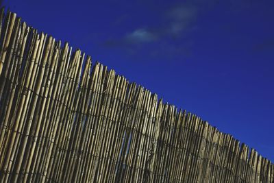 Low angle view of modern building against blue sky