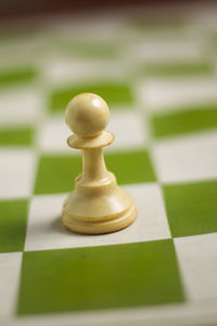 Close-up of chess pieces on table