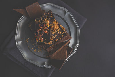 Close-up of chocolate bars with star anise in plate on table